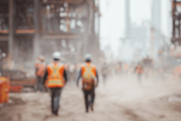 blurred image of construction workers onsite