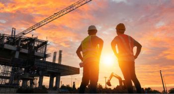 construction workers discussing project plans at a busy worksite